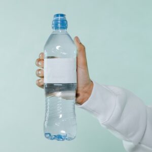 Photo of a Person's Hand Holding a Bottle of Water